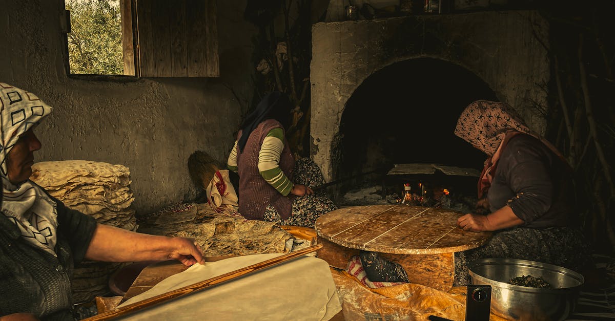 A rustic village scene in Antalya, Türkiye, showcasing traditional Turkish baking methods with women making flatbread.